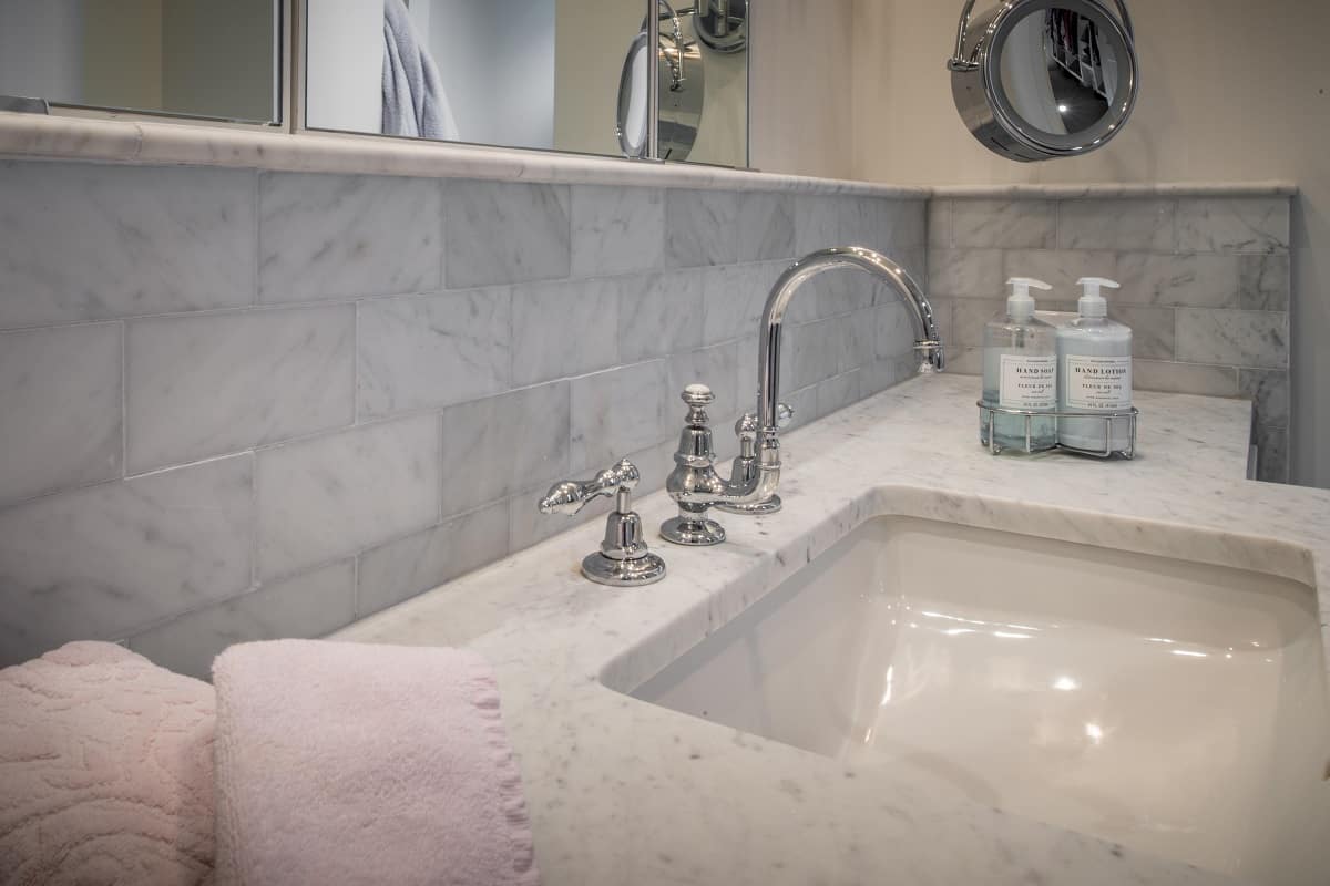close up of a white marble bathroom sink