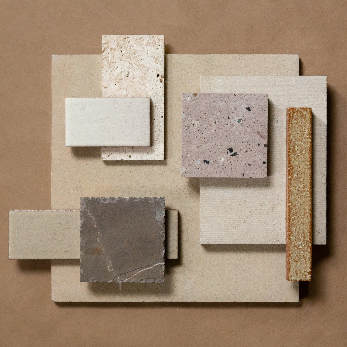 A flatlay showcase of different colored natural stone tiles