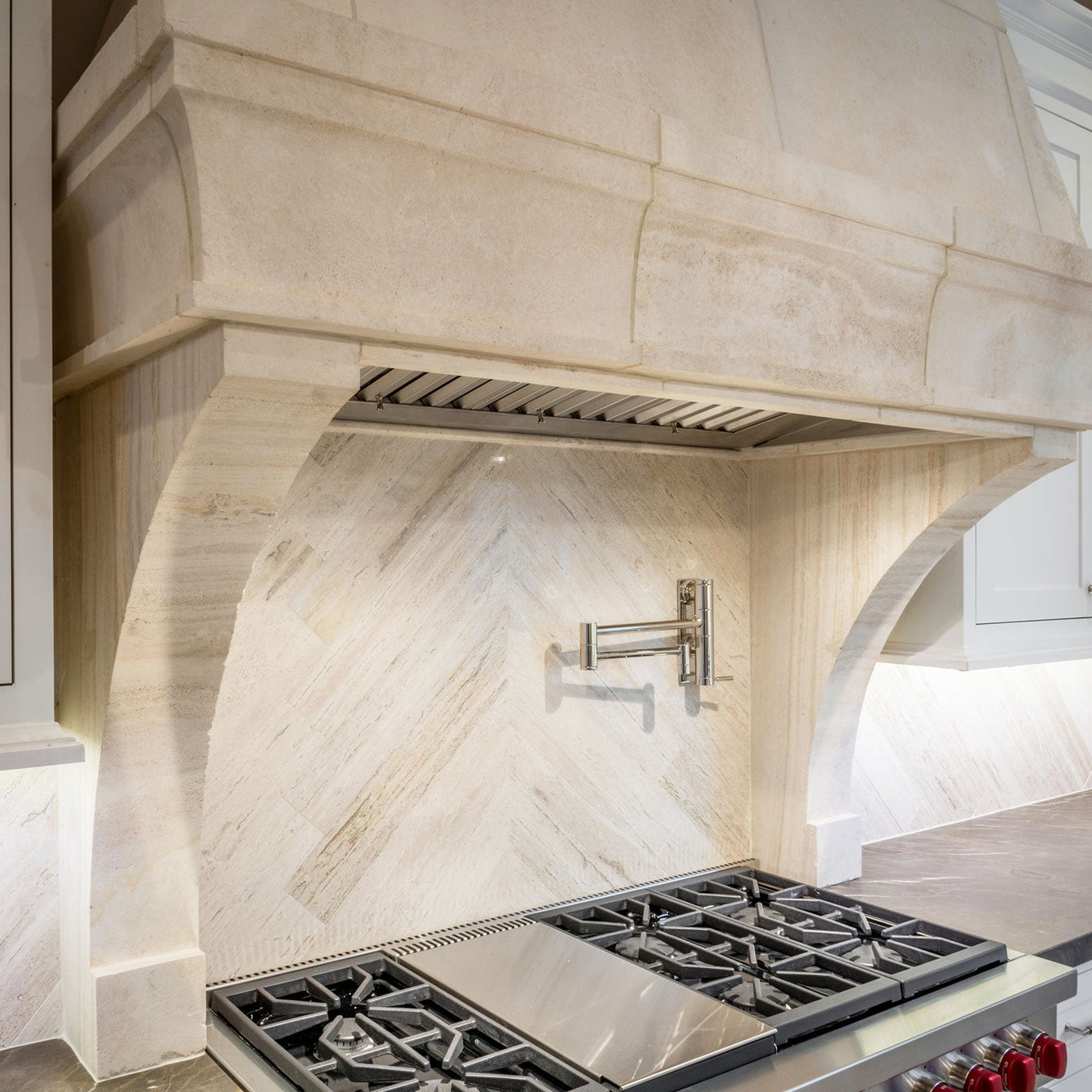 tan marble kitchen hood over a stove