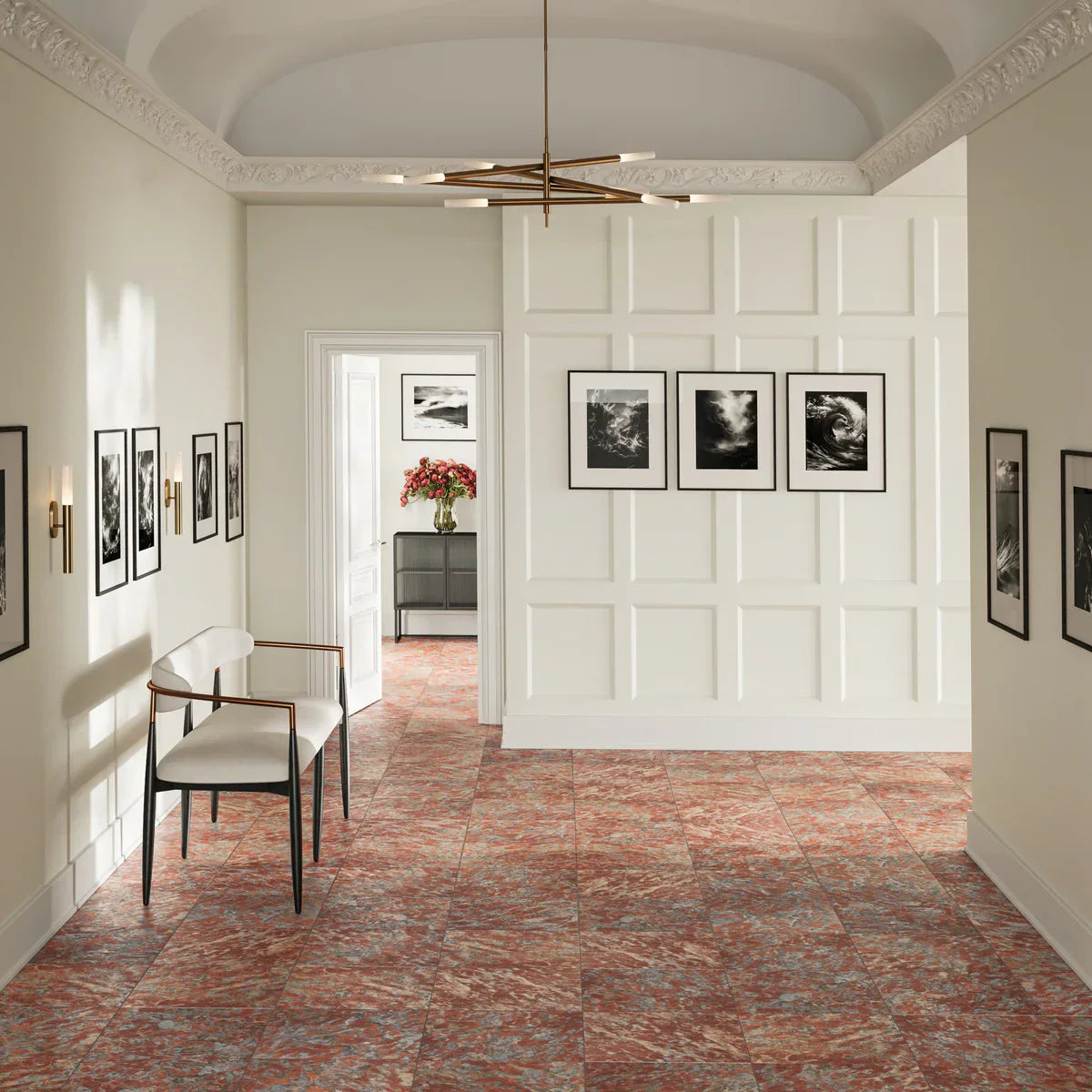 red marbled flooring and a white wall that has three hanging pictures