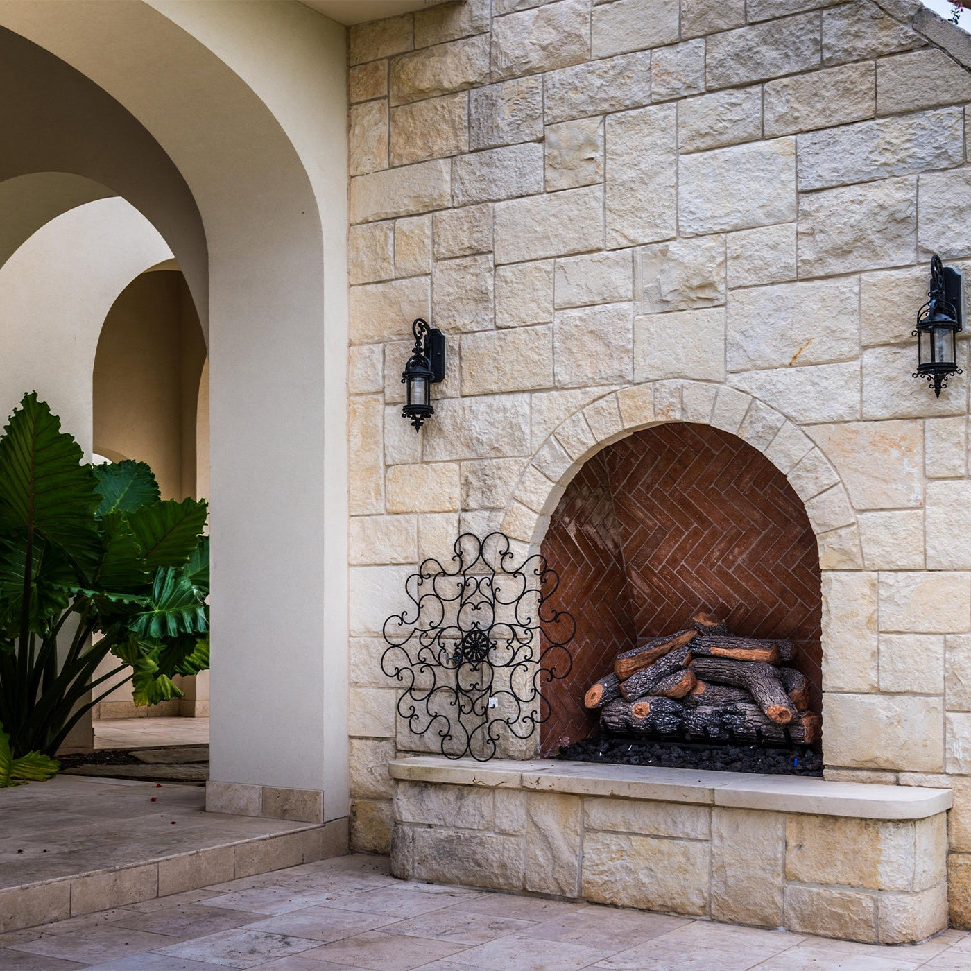 outdoor fireplace in a white stone wall
