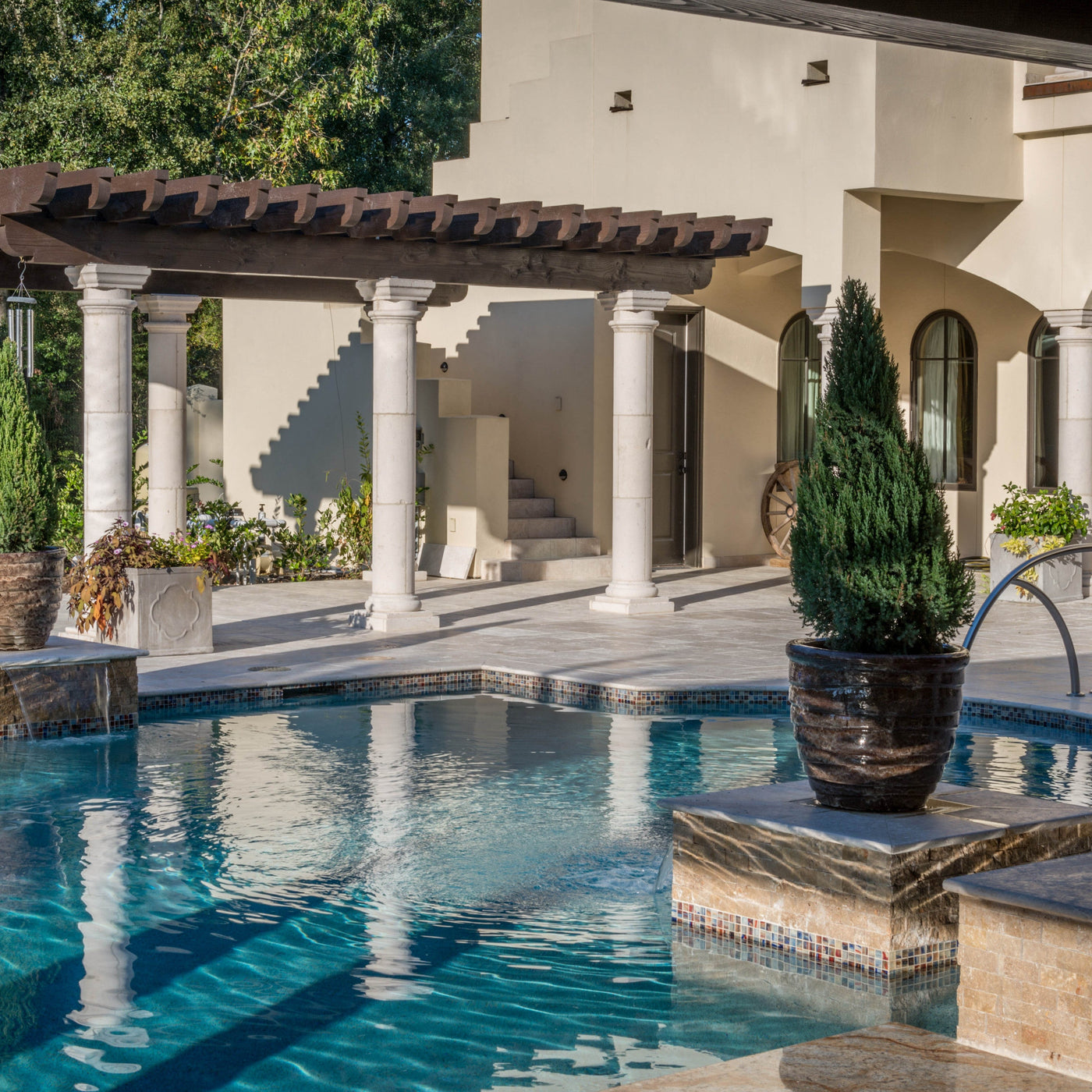 outdoor pool with a white pillared shading area in the background