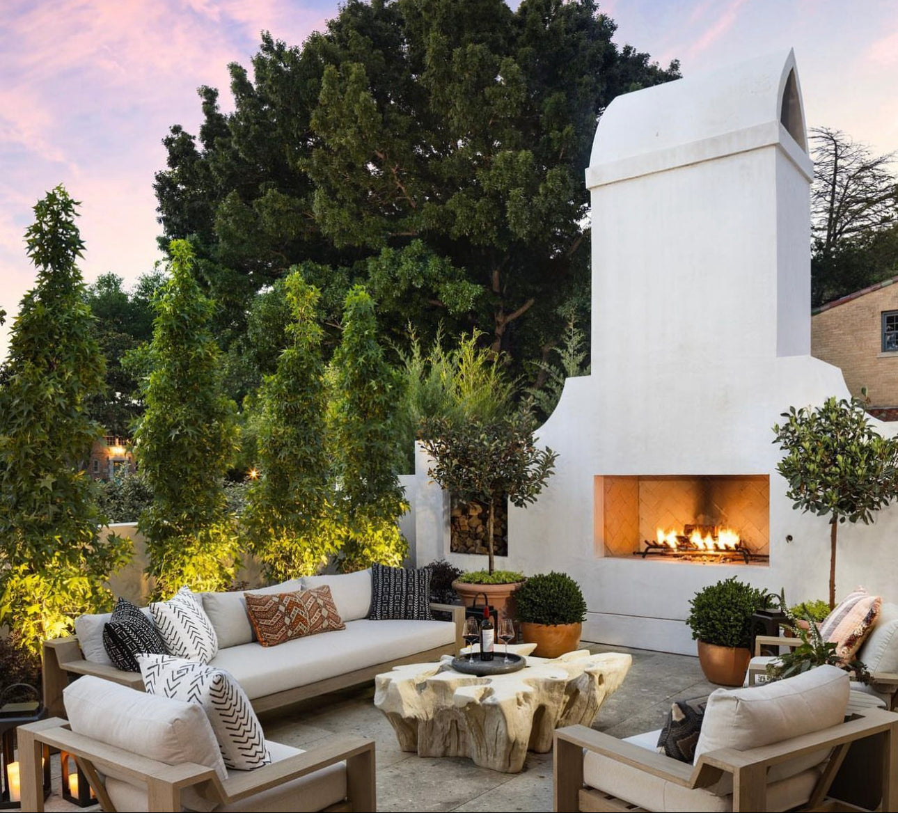 outdoor patio with furniture and a white stone fireplace