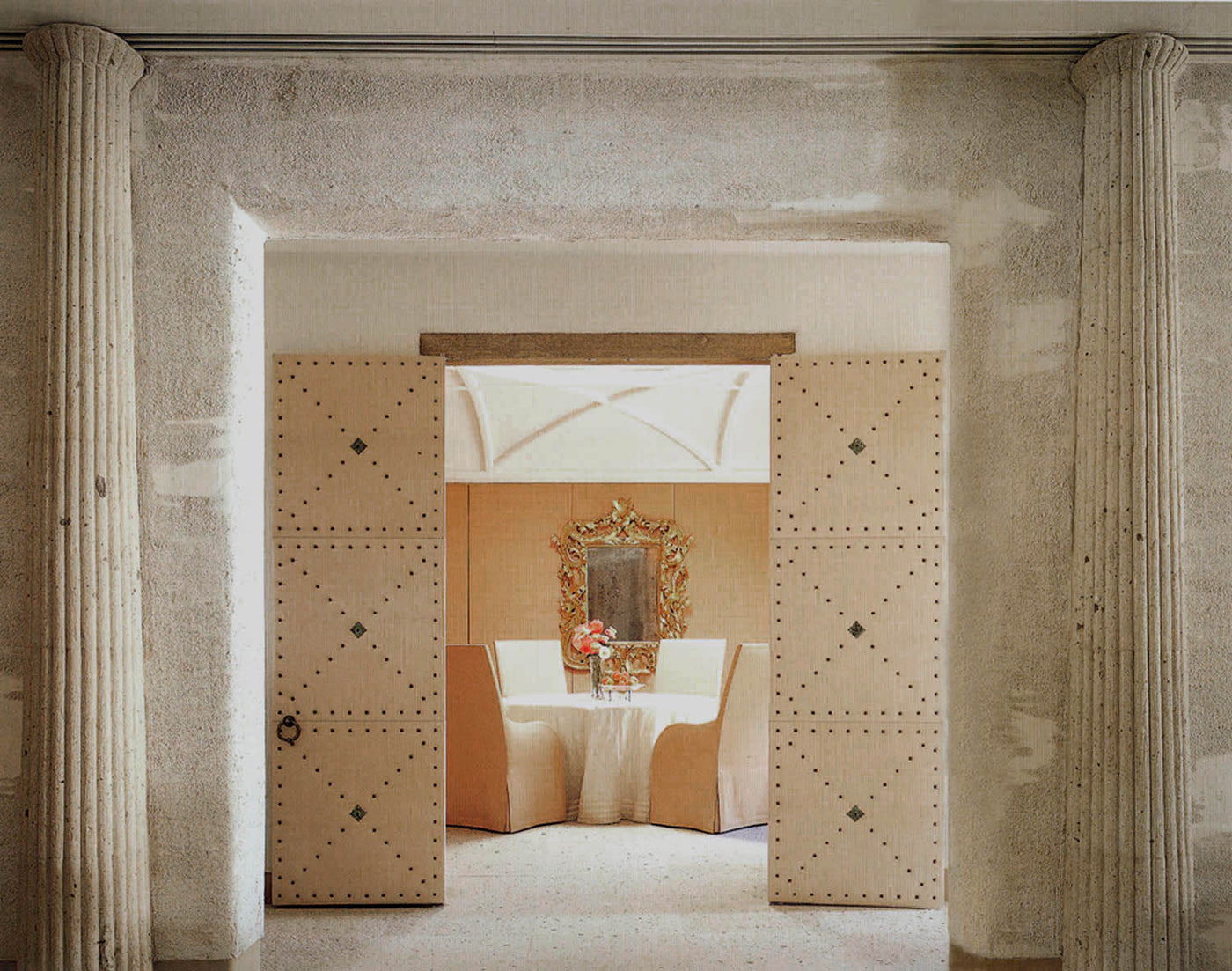 simple decorative doorway leading to a table and two chairs