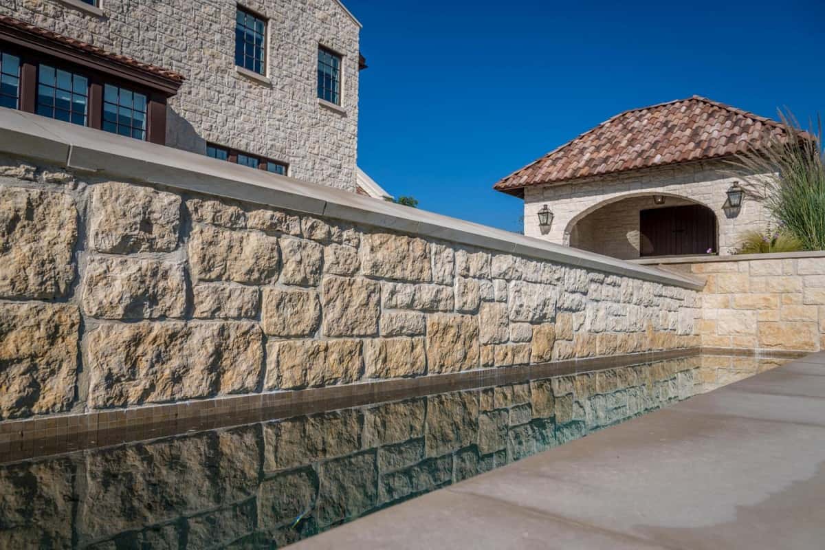 close up of a rock wall next to a pool