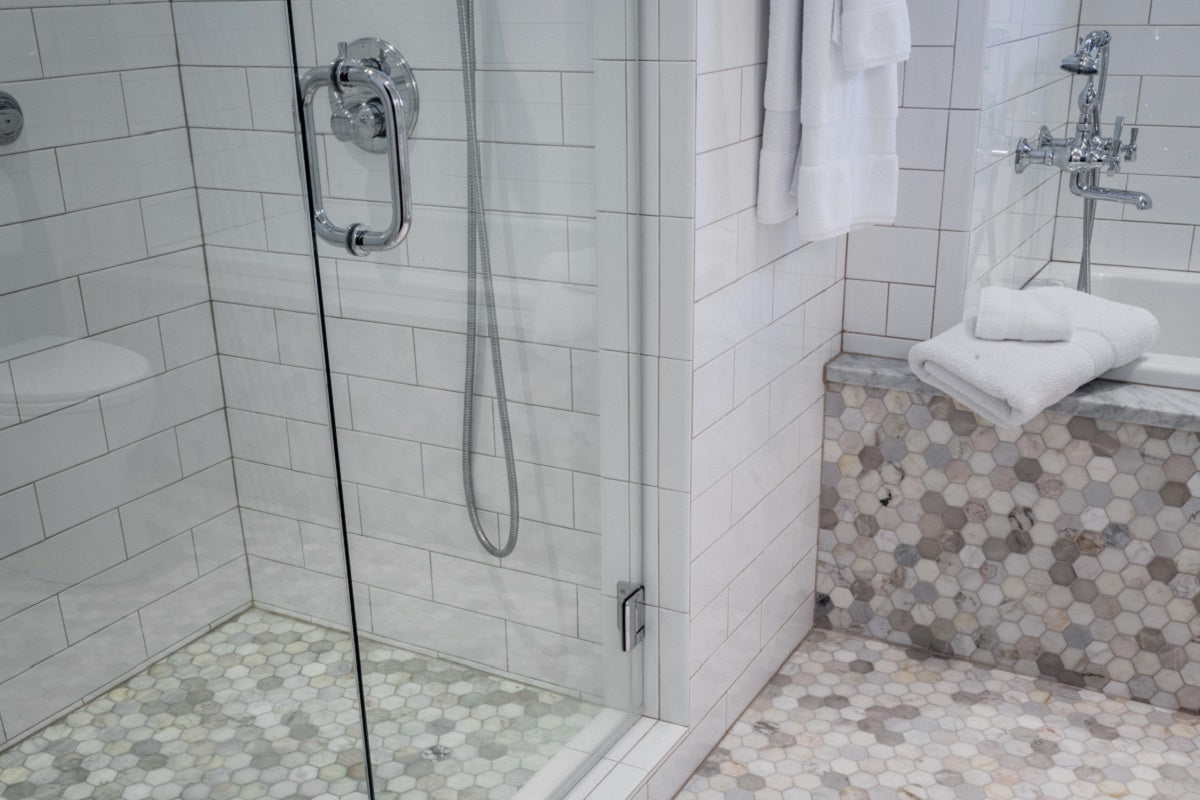 White bathroom shower and bath area showcasing tiles