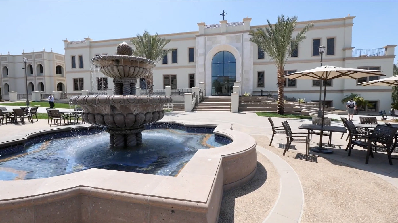water fountain in front of a white building