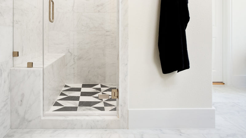 Bathroom floor and shower featuring Alba Vera, Nero, and Montclair Marbles Mobile