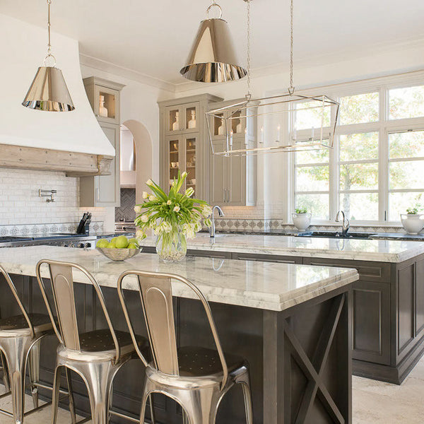 Modern kitchen with marble island and stainless steel chairs